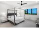 Main bedroom with ocean views and a four-poster bed at 15617 Pendio Dr, Bella Collina, FL 34756