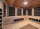Modern wood-paneled sauna with multiple benches at 15617 Pendio Dr, Bella Collina, FL 34756