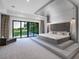 Main bedroom with a platform bed and sliding glass doors to the backyard at 15617 Pendio Dr, Bella Collina, FL 34756