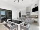 Outdoor kitchen with stainless steel appliances and seating area at 15617 Pendio Dr, Bella Collina, FL 34756