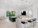 Modern living area with a large sectional and a marble-topped kitchen island at 15617 Pendio Dr, Bella Collina, FL 34756