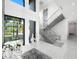 Bright entryway with modern staircase and views to backyard at 15617 Pendio Dr, Bella Collina, FL 34756
