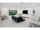 Sophisticated living room with a large sectional sofa and a wall-mounted TV at 15617 Pendio Dr, Bella Collina, FL 34756