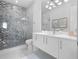 Bathroom with a walk-in shower and chevron tile at 15617 Pendio Dr, Bella Collina, FL 34756