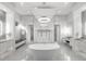 Luxurious bathroom with a large soaking tub and glass shower at 15617 Pendio Dr, Bella Collina, FL 34756