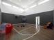 Indoor basketball court with hardwood floors and seating at 15617 Pendio Dr, Bella Collina, FL 34756