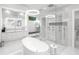 Luxurious bathroom with a large soaking tub and glass shower at 15617 Pendio Dr, Bella Collina, FL 34756