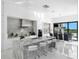 Modern kitchen with marble countertops and island at 15617 Pendio Dr, Bella Collina, FL 34756
