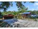 Front view of the house, detached garage, and landscaping at 151 S Clayton St, Mount Dora, FL 32757