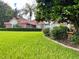 One-story house with red tile roof and manicured lawn at 39331 Treeline Dr, Lady Lake, FL 32159
