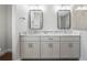 Double vanity bathroom with marble countertops and modern mirrors at 577 Dowling Cir, Lady Lake, FL 32159