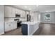 Modern kitchen with white cabinets, stainless steel appliances, and a center island at 577 Dowling Cir, Lady Lake, FL 32159