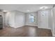 Bright and airy living room with wood-look tile floors and a view of the front yard at 577 Dowling Cir, Lady Lake, FL 32159