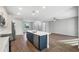 Open-concept kitchen with island, stainless steel appliances, and a view of the living room at 577 Dowling Cir, Lady Lake, FL 32159