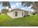 View of the house exterior, showcasing the backyard and landscaping at 5206 Fantasy Way, Leesburg, FL 34748