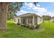 Home exterior showcasing a screened porch and backyard at 5206 Fantasy Way, Leesburg, FL 34748