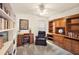 Bright home office features built-in shelving and a comfortable armchair at 5206 Fantasy Way, Leesburg, FL 34748