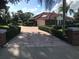 Brick-paved driveway leading to a charming two-story house at 39331 Treeline Dr, Lady Lake, FL 32159