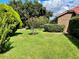 Neatly landscaped side yard with green grass and manicured shrubs at 39331 Treeline Dr, Lady Lake, FL 32159