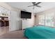 Bedroom with large TV, dresser, and teal bedding at 2630 Mcdonald Ter, Mount Dora, FL 32757