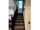 Carpeted staircase with dark wood railings at 101 S Dixie Ave, Fruitland Park, FL 34731