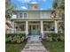 Two-story home with a large front porch and landscaping at 101 S Dixie Ave, Fruitland Park, FL 34731