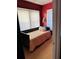 Cozy bedroom with a daybed and red painted walls at 101 S Dixie Ave, Fruitland Park, FL 34731