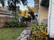 Landscaped side yard with a stone path and colorful flowers at 101 S Dixie Ave, Fruitland Park, FL 34731