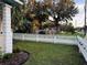 Charming home with a white picket fence and well-manicured lawn at 101 S Dixie Ave, Fruitland Park, FL 34731