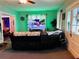 Living room with comfortable seating and a large TV at 101 S Dixie Ave, Fruitland Park, FL 34731
