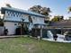 Two-story house with a metal roof, a spa, and a grassy backyard at 101 S Dixie Ave, Fruitland Park, FL 34731