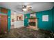 Living room with teal walls, fireplace, and wood floors at 1240 Tangerine Ct, Eustis, FL 32726