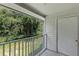 Private balcony overlooking lush green trees and landscaping at 11508 Westwood Blvd # 328, Orlando, FL 32821