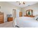 Well-lit bedroom with a ceiling fan and wood furniture at 5500 Belle Terre Dr, Leesburg, FL 34748