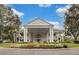 Elegant community clubhouse with columns and landscaping; impressive entryway at 5500 Belle Terre Dr, Leesburg, FL 34748