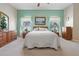 Bright bedroom with carpeted floor, ceiling fan, and wood furniture at 5500 Belle Terre Dr, Leesburg, FL 34748