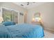 Spacious bedroom with a queen bed and mirrored closet doors at 5500 Belle Terre Dr, Leesburg, FL 34748