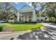 Community clubhouse with circular driveway and lush landscaping; inviting curb appeal at 5500 Belle Terre Dr, Leesburg, FL 34748