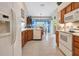 Bright kitchen with white appliances and wood cabinets at 5500 Belle Terre Dr, Leesburg, FL 34748
