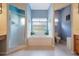 Relaxing bathroom with a soaking tub, shower, and updated fixtures at 5500 Belle Terre Dr, Leesburg, FL 34748