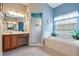 Clean bathroom, featuring a vanity, shower, and garden tub at 5500 Belle Terre Dr, Leesburg, FL 34748