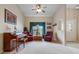 Sitting area with piano, two armchairs, and a window with curtains at 5500 Belle Terre Dr, Leesburg, FL 34748