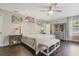Bright bedroom with king-size bed, hardwood floors, and coastal decor at 151 S Clayton St, Mount Dora, FL 32757