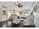 Cozy living room featuring hardwood floors, comfortable seating, and coastal decor at 151 S Clayton St, Mount Dora, FL 32757