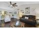 Living room with hardwood floors, a brown leather couch, and coastal decor at 151 S Clayton St, Mount Dora, FL 32757