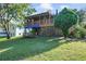Charming home with a spacious deck and well-manicured lawn at 151 S Clayton St, Mount Dora, FL 32757
