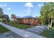 Quaint cottage-style home with metal roof and inviting porch at 151 S Clayton St, Mount Dora, FL 32757