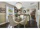 Charming dining room with glass-top table, chandelier, and hardwood floors at 151 S Clayton St, Mount Dora, FL 32757