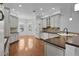 Bright kitchen with an island, hardwood floors, and white cabinets at 2079 Clarks Hill Way, The Villages, FL 32162