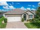 One-story home with attached garage and landscaping at 3450 Landing Vw, Tavares, FL 32778